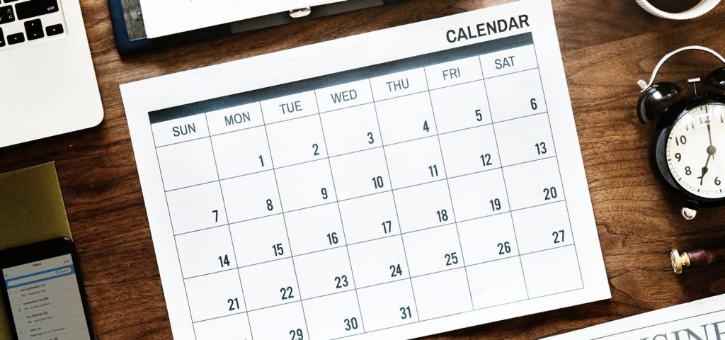 calendar surrounded by office supplies