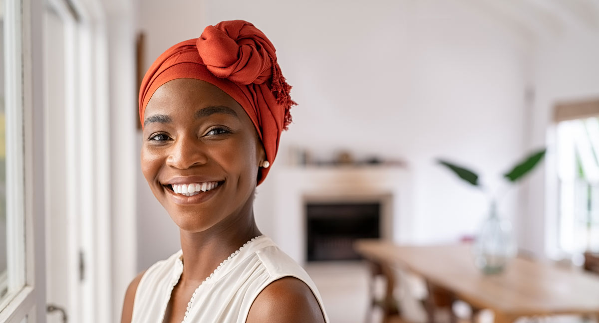 woman with head scarf smiling