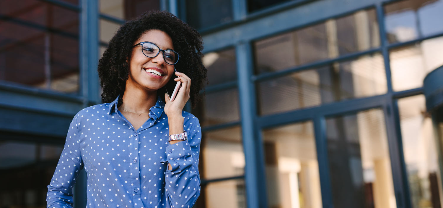 woman smiling while talking on phone