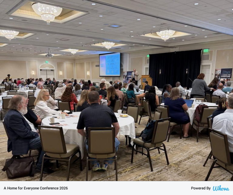 Conference room view showing attendees at tables
