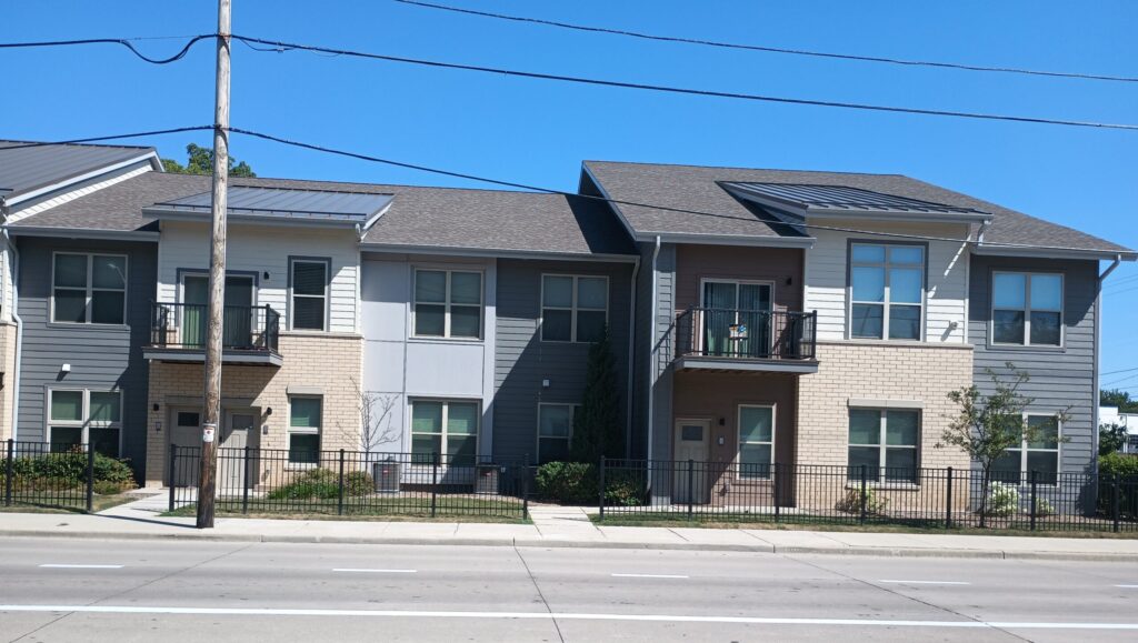 Exterior street view of one of the stacked-flat buildings in the Spring City Crossing campus
